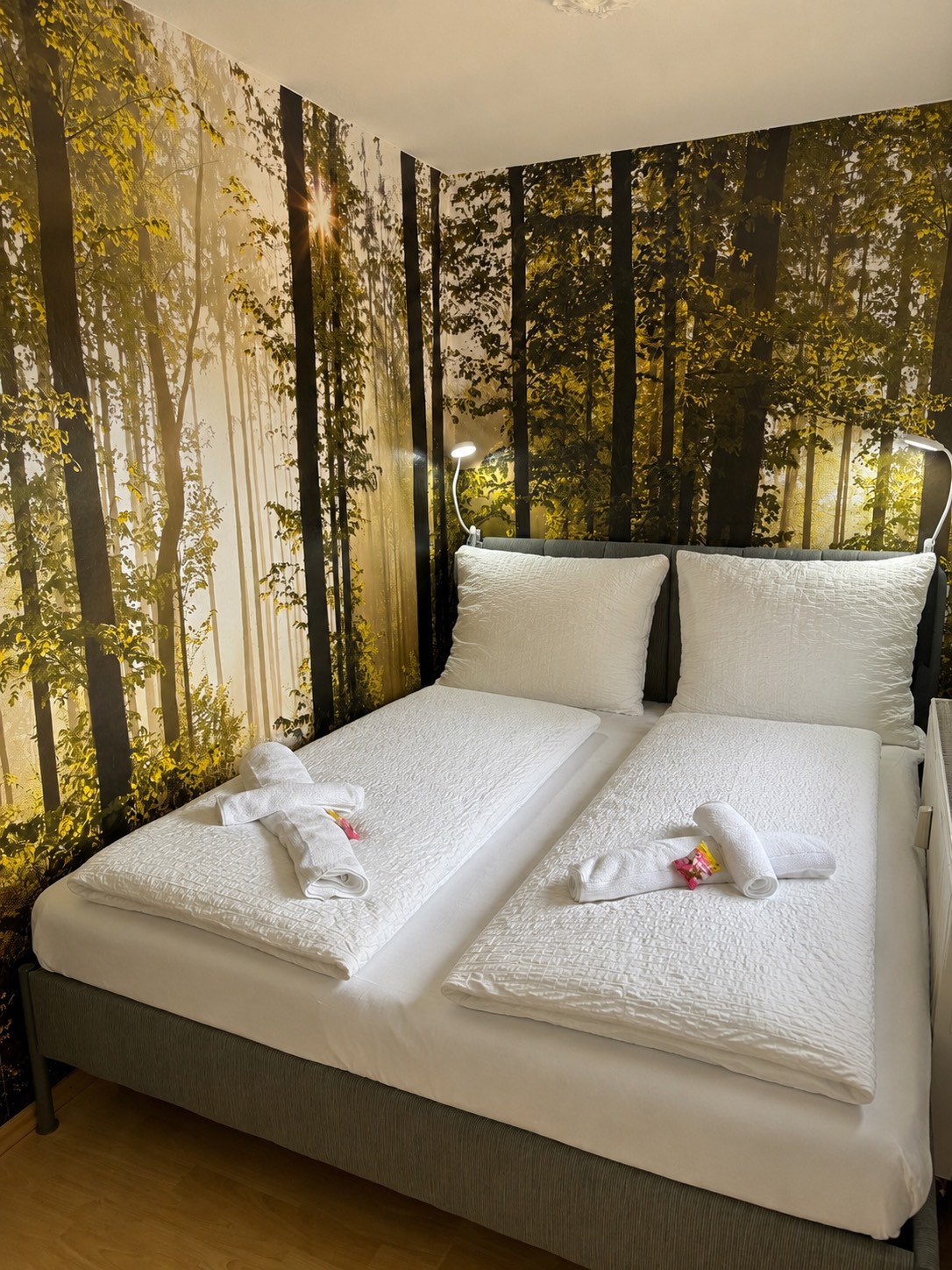Waldschlafecke mit frisch gemachtem Bett und Waldtapete